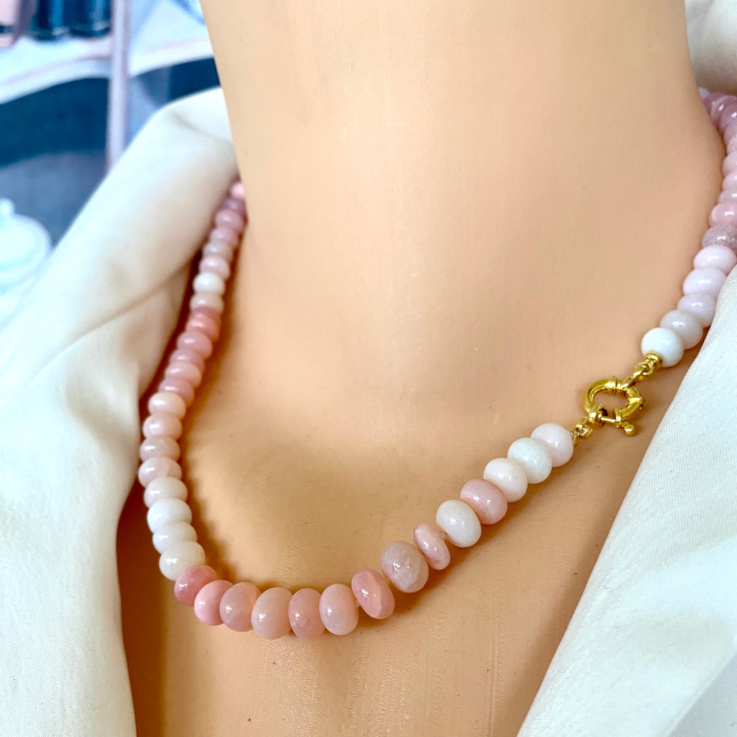 Pink opal beaded necklace on mannequin showing bead detail