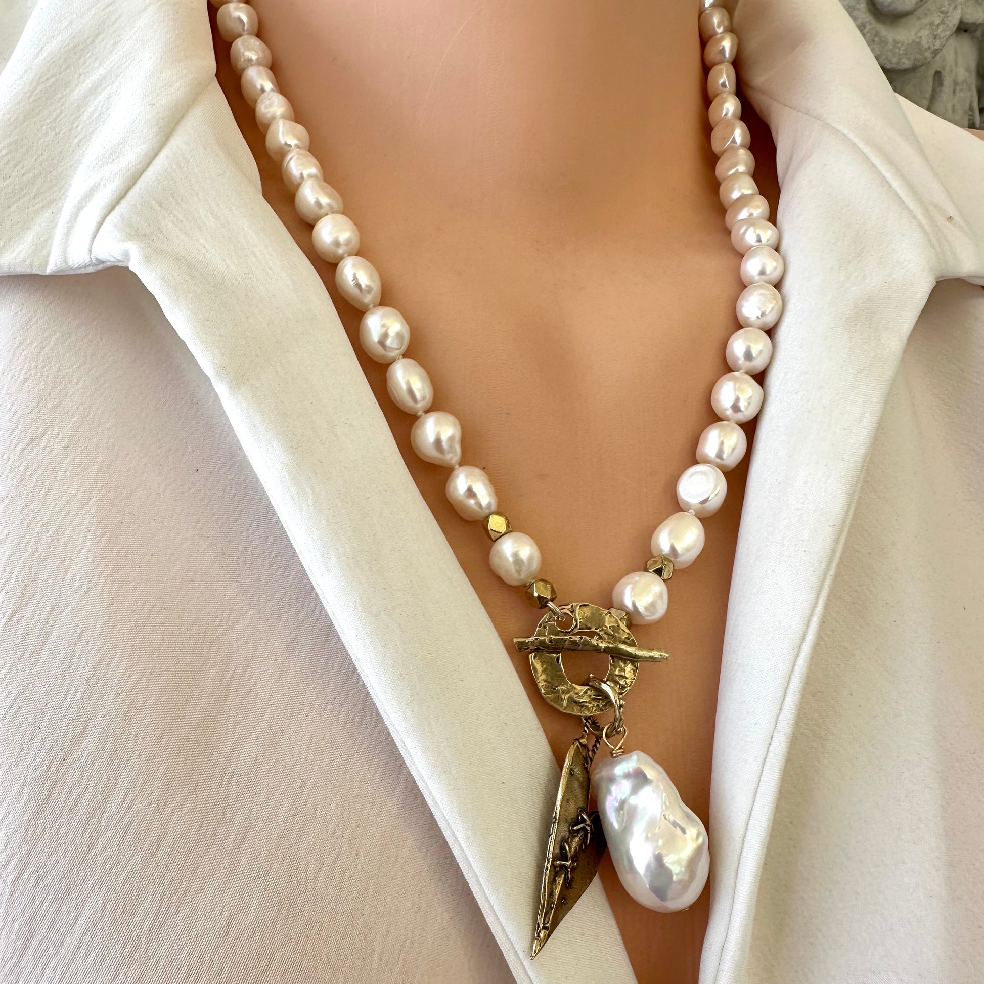 Pearl toggle necklace with heart and baroque pearl pendants on mannequin