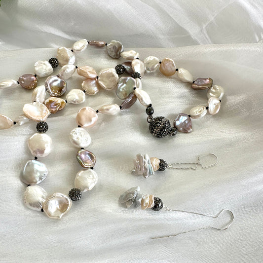 Gray and peach pearl threader earrings – sterling silver petal design displayed with a pearl necklace.