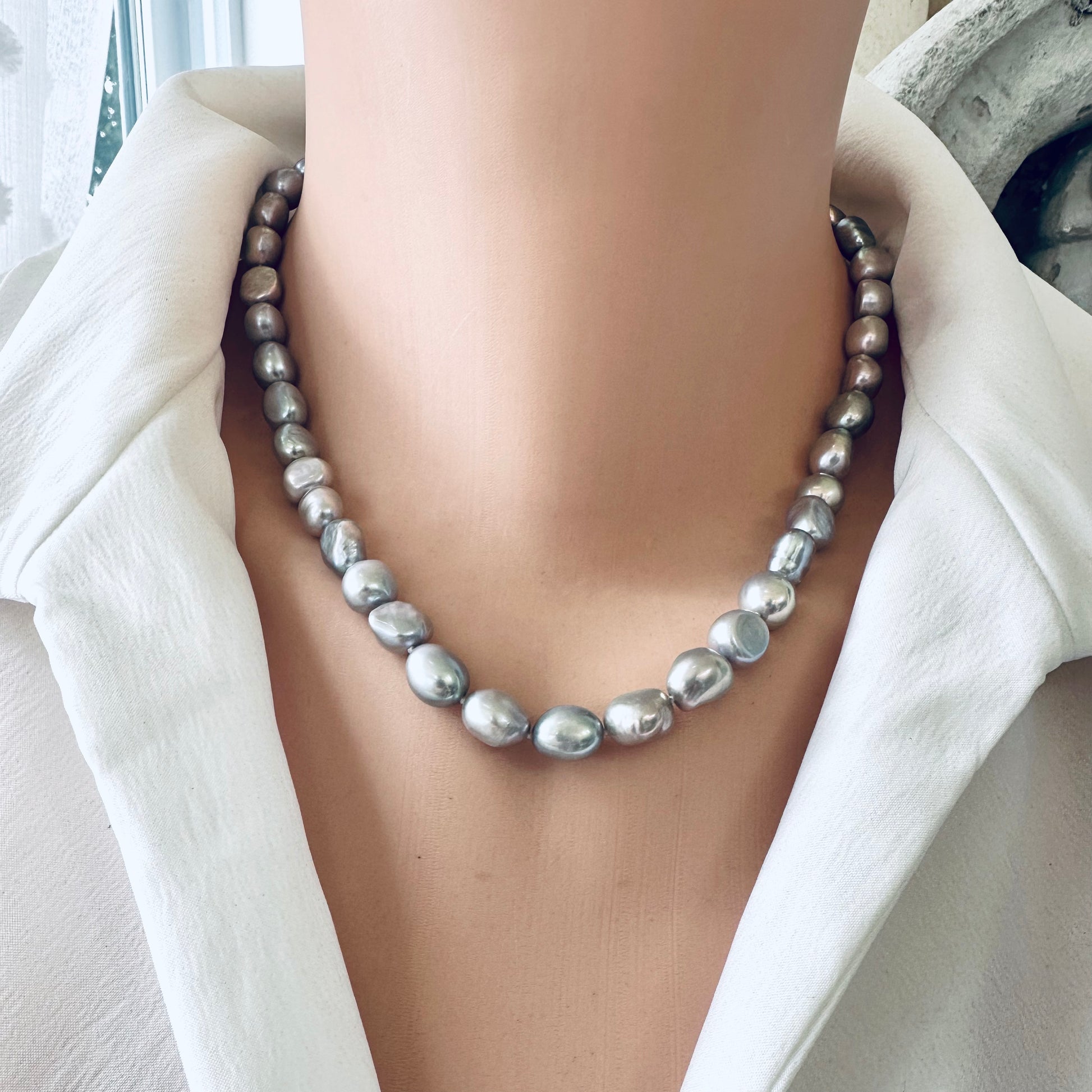 Grey pearl necklace showcasing silver-grey freshwater nugget pearls, emitting elegance and sophistication.