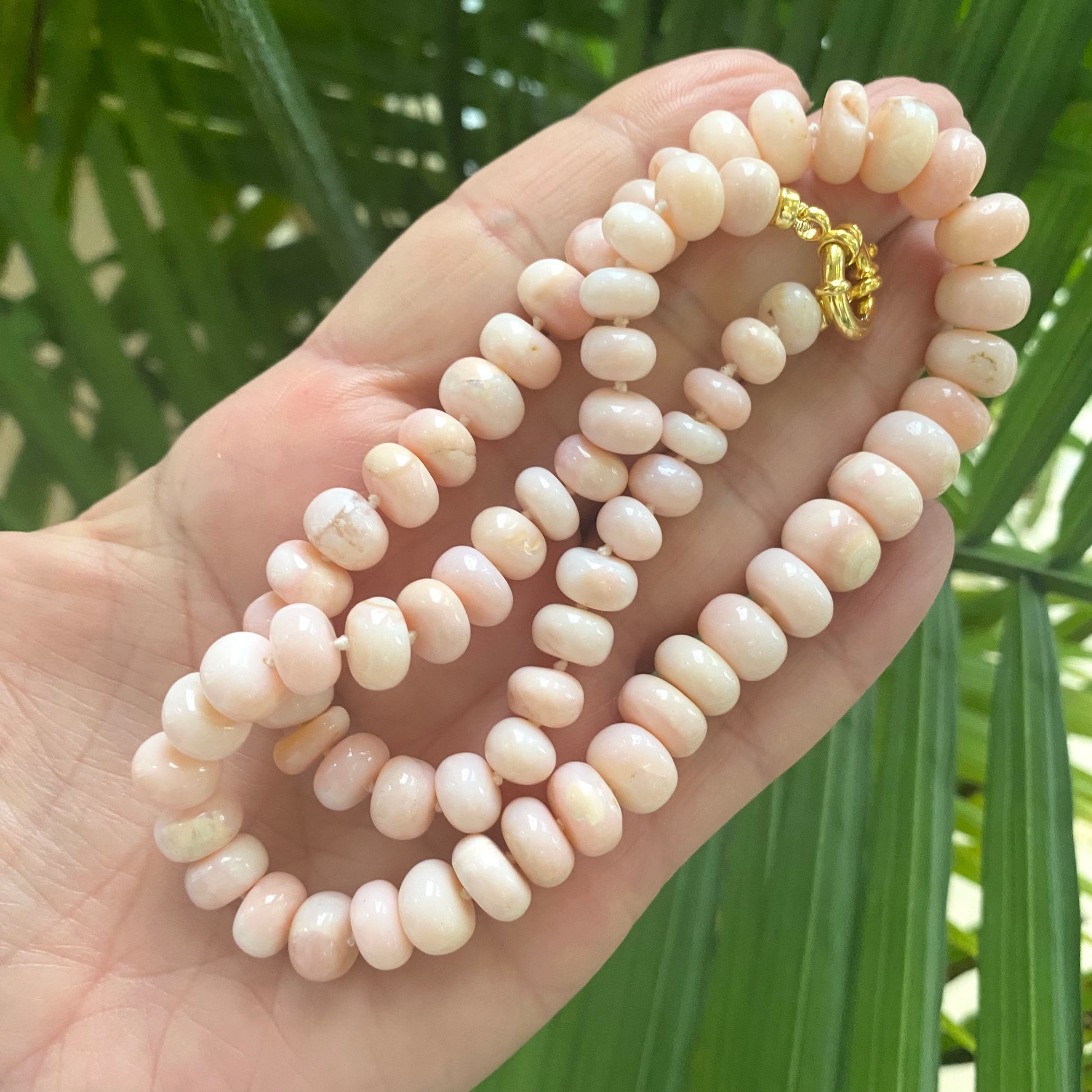 Graduated Pink Opal Necklace Gold close-up in hand, 8–11mm graduated pink opal rondelles and gold clasp