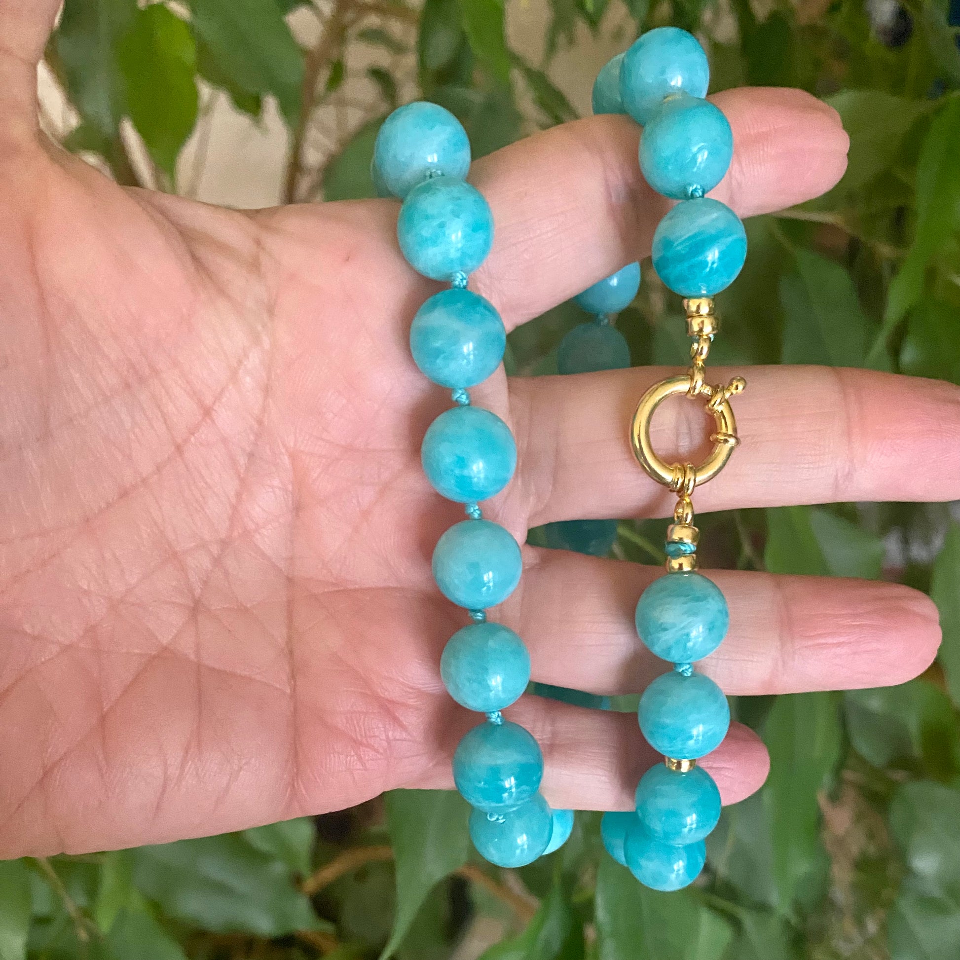 Blue Amazonite Beaded Necklace showing large blue beads and gold clasp, handmade in Canada.