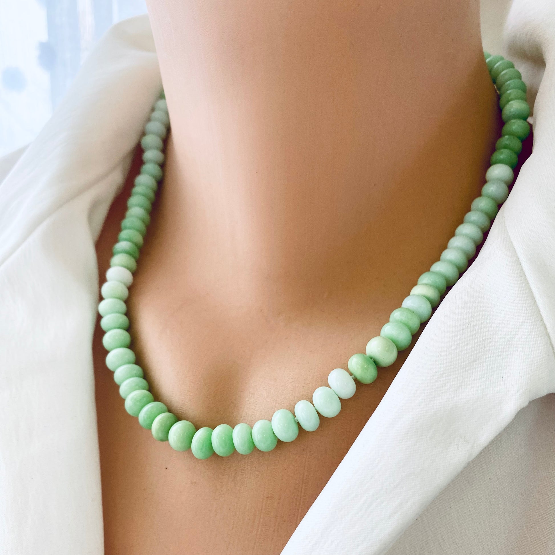 Green opal beaded necklace worn on mannequin, front close-up