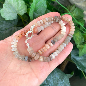 Hand-knotted candy choker necklace featuring 6mm faceted moonstone, labradorite, and sunstone beads, with a sterling silver marine clasp. The necklace measures 16 inches and offers a colorful and elegant design.