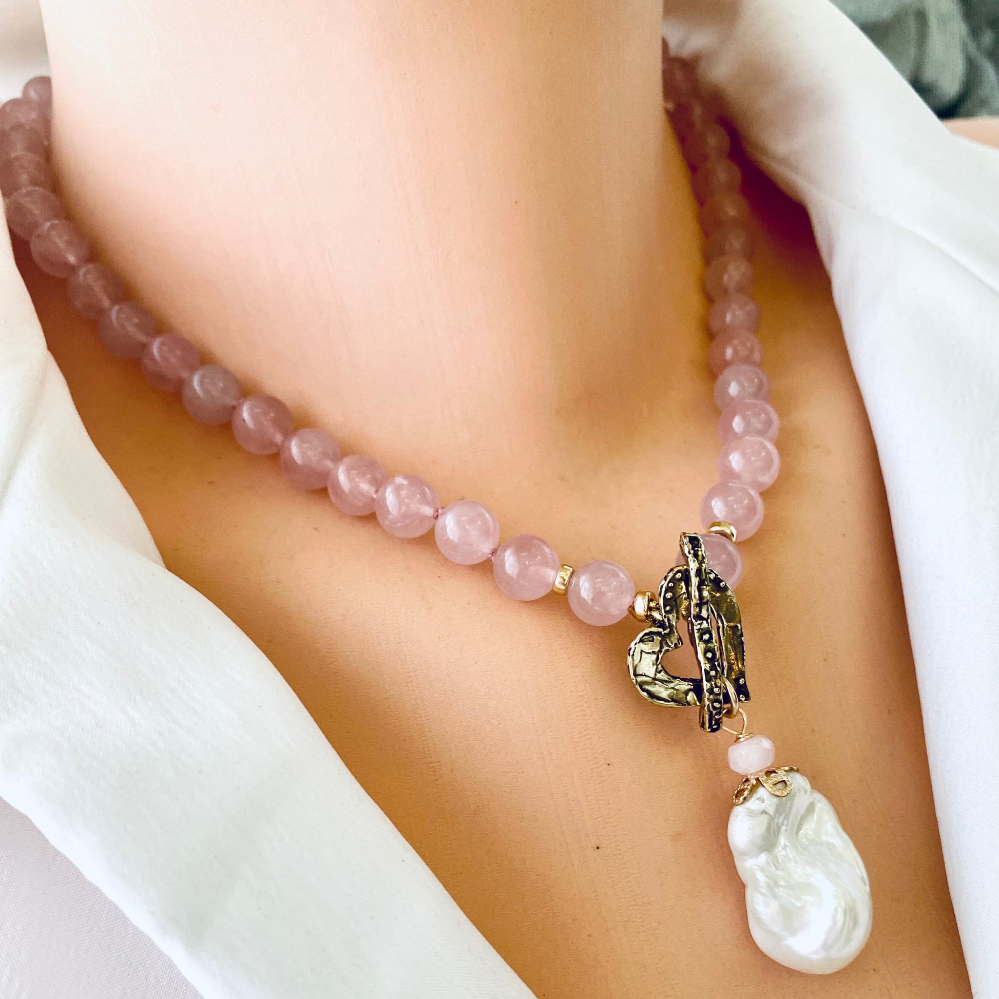 Rose quartz pearl necklace worn on mannequin, front close-up