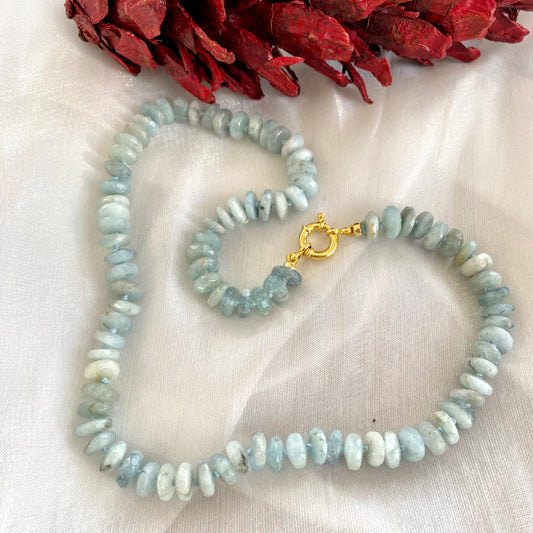 Aquamarine beaded necklace displayed on white cloth