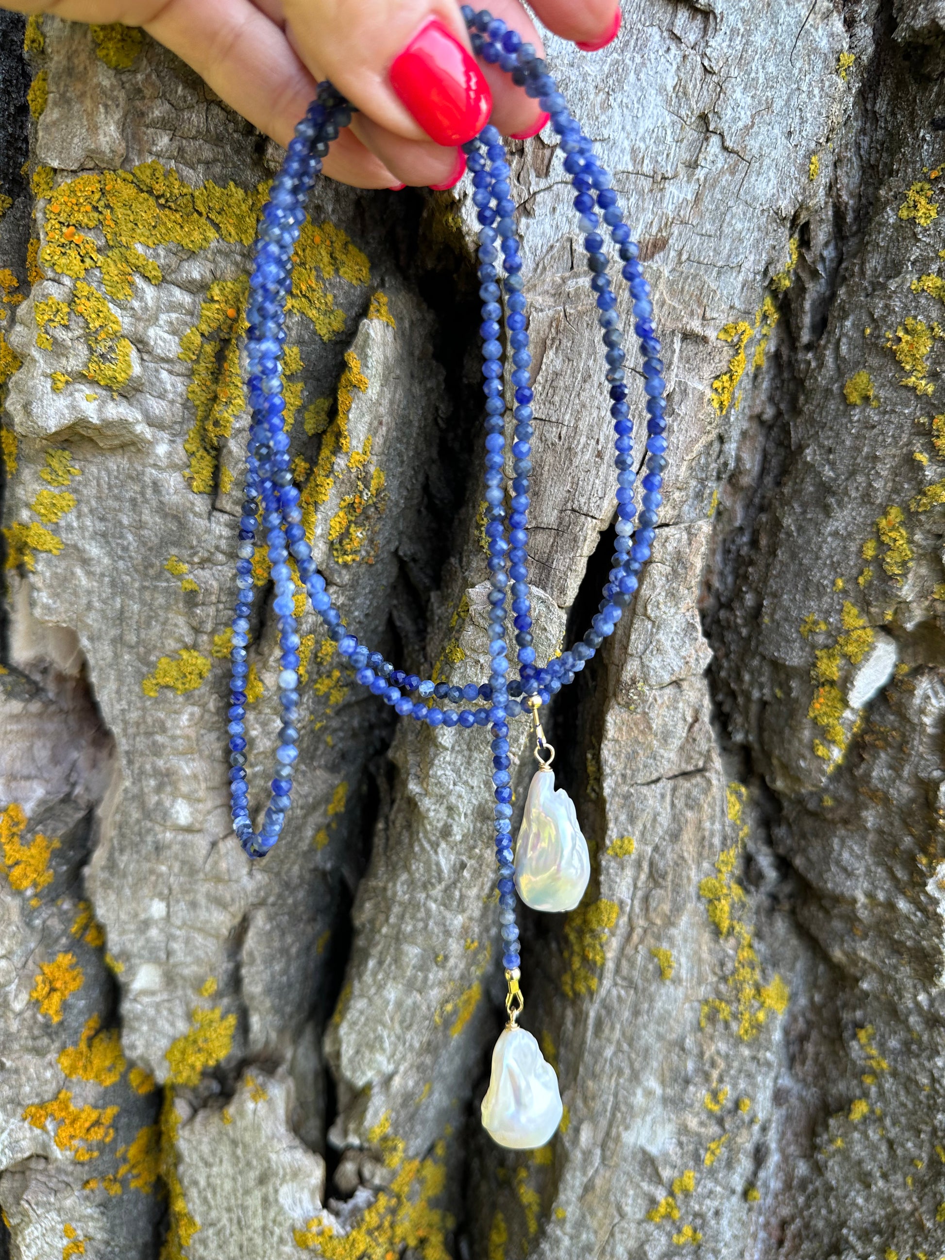 Sodalite baroque pearl lariat necklace photographed outdoors emphasizing natural gemstones