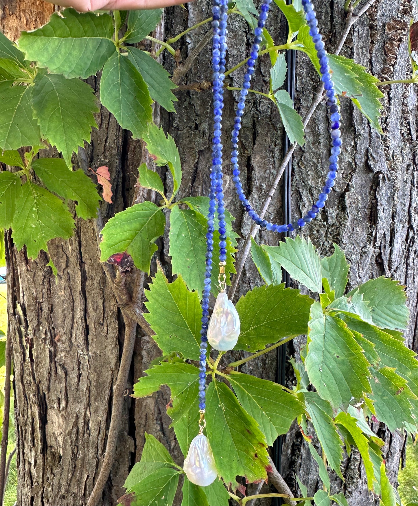 Sodalite baroque pearl lariat necklace hanging vertically highlighting wrap length and pearls