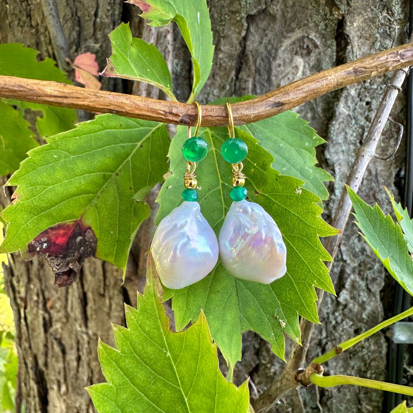 White baroque pearl drop earrings with green agate accent beads, showcasing timeless elegance and natural beauty.
