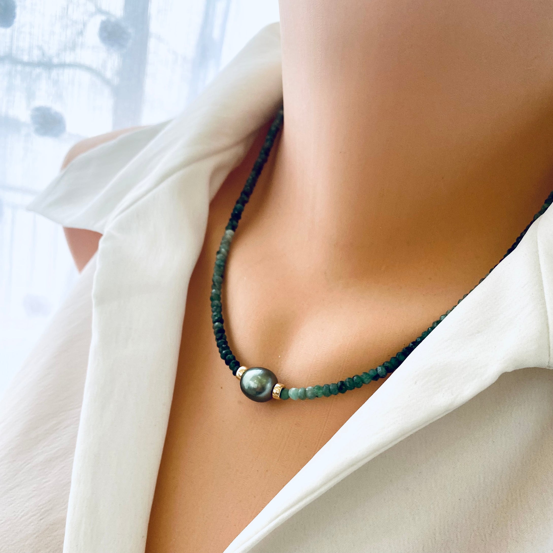 Stunning shaded  green Necklace featuring faceted Emerald roundelle beads and a greenish black Tahitian Pearl centerpiece. May birthstone Gift For Her. Crafted with gold filled, the necklace measures 18.5 inches in length