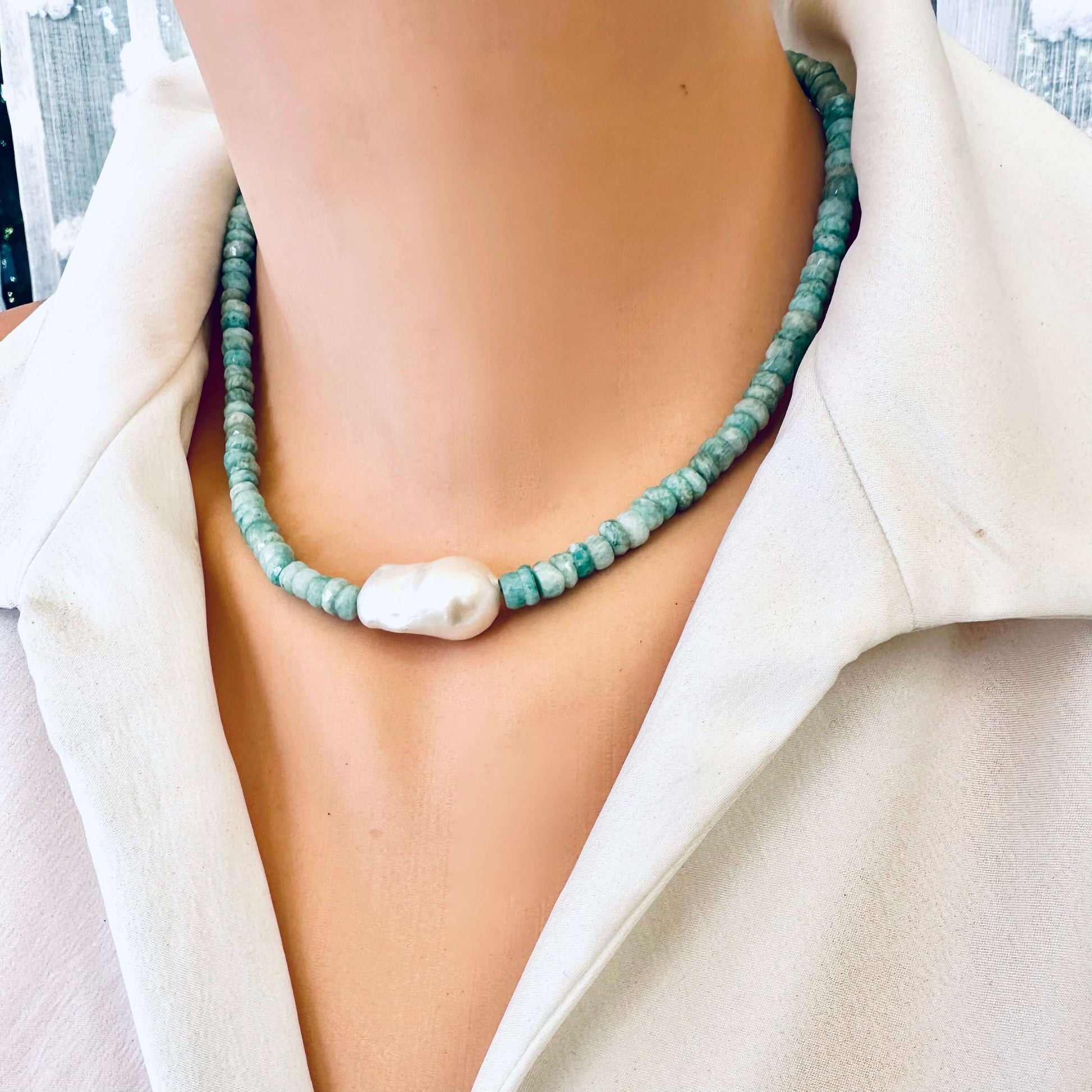 Amazonite and white baroque pearl necklace worn by mannequin, frontal close-up