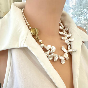 Stunning 19" white Keshi pearls necklace, featuring a unique asymmetrical design that showcases both petal-shaped and nugget pearls with a beautiful golden vine leaf toggle clasp making this necklace not only easy to wear but a striking focal point.
