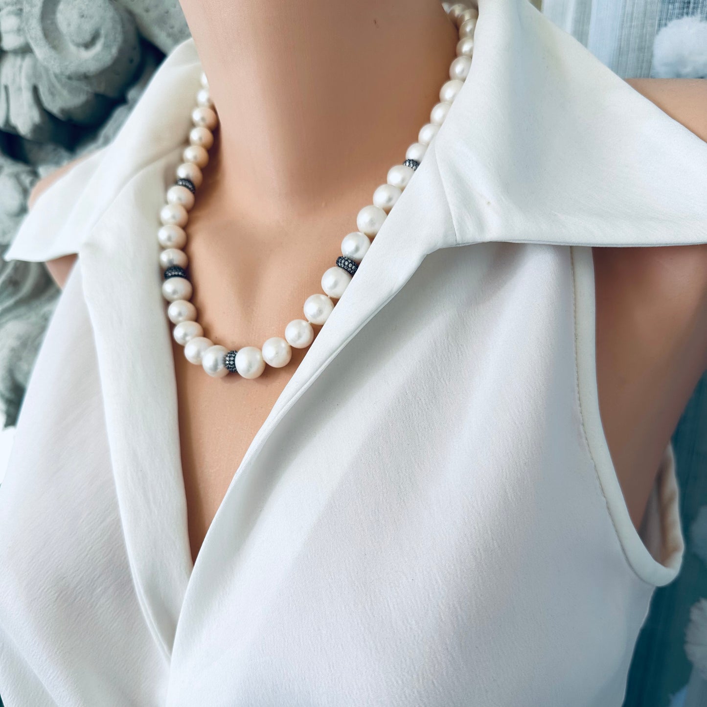 Pearl necklace featuring white freshwater pearls and zircon pave beads, showcasing elegance and sophistication.