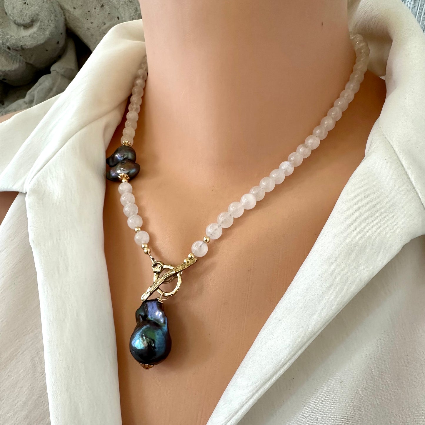 Moonstone necklace with black baroque pearl, handcrafted in Canada, featured on a mannequin.