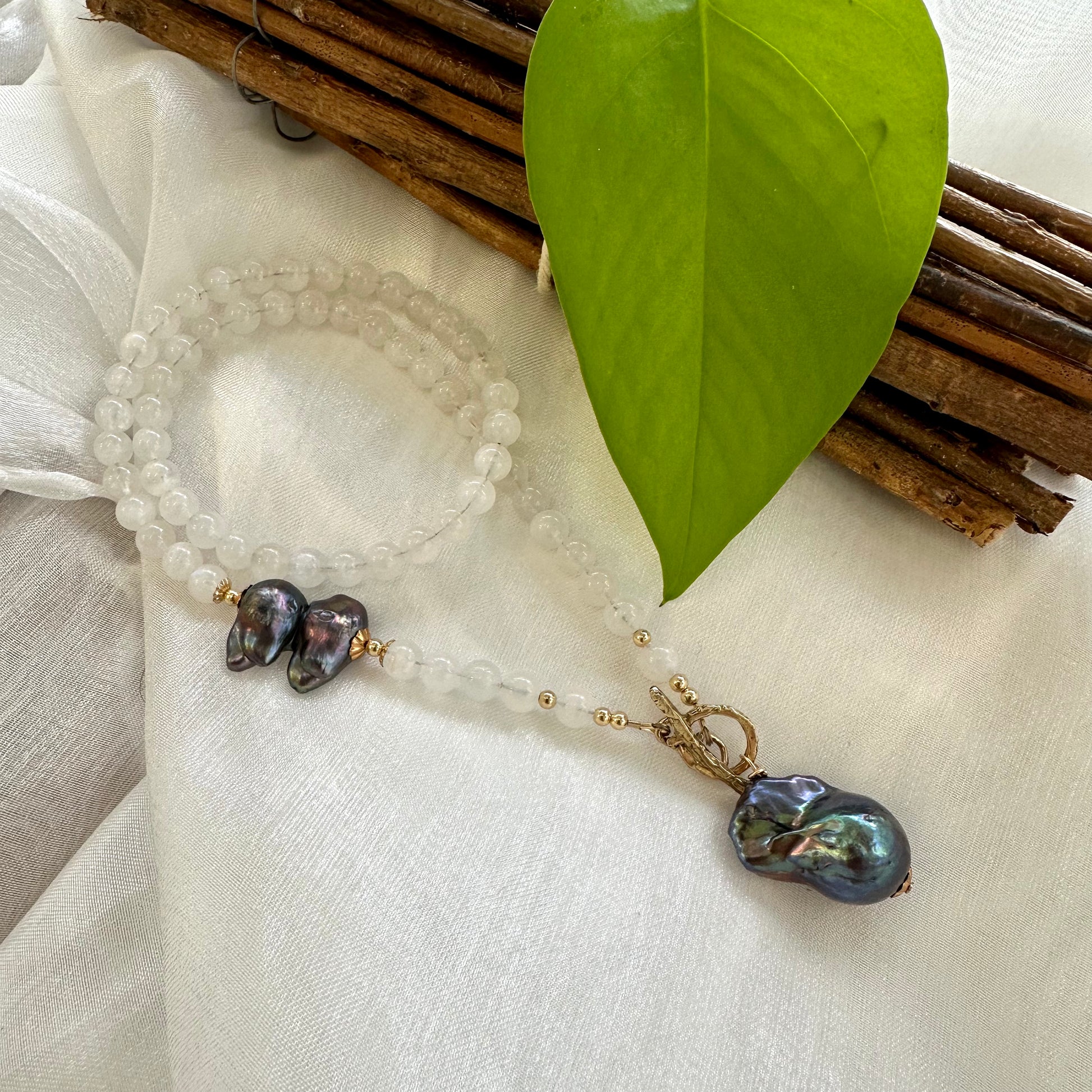 Moonstone necklace with black baroque pearl, handmade in Canada, featuring white moonstone beads and unique pearl accents.