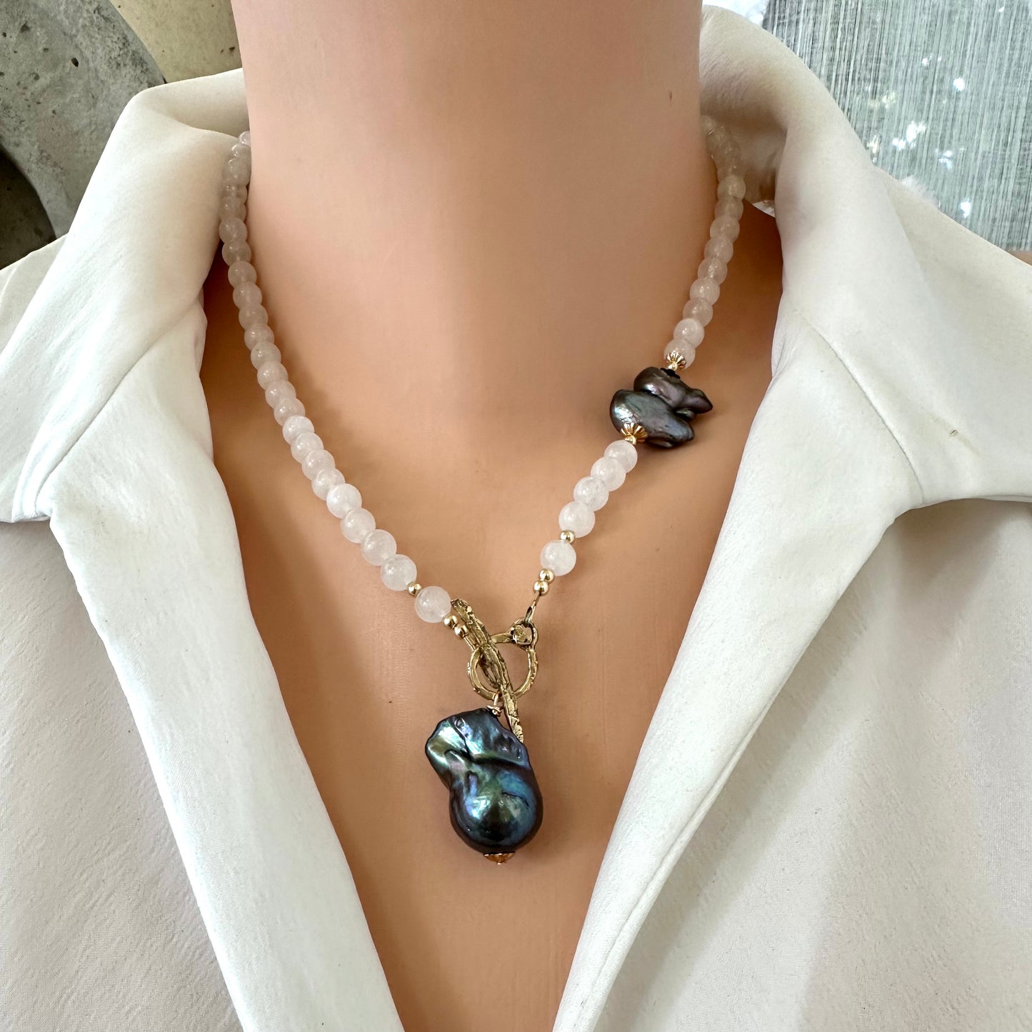 Moonstone necklace with black baroque pearl, handmade in Canada, showcasing iridescent white and bold black accents.