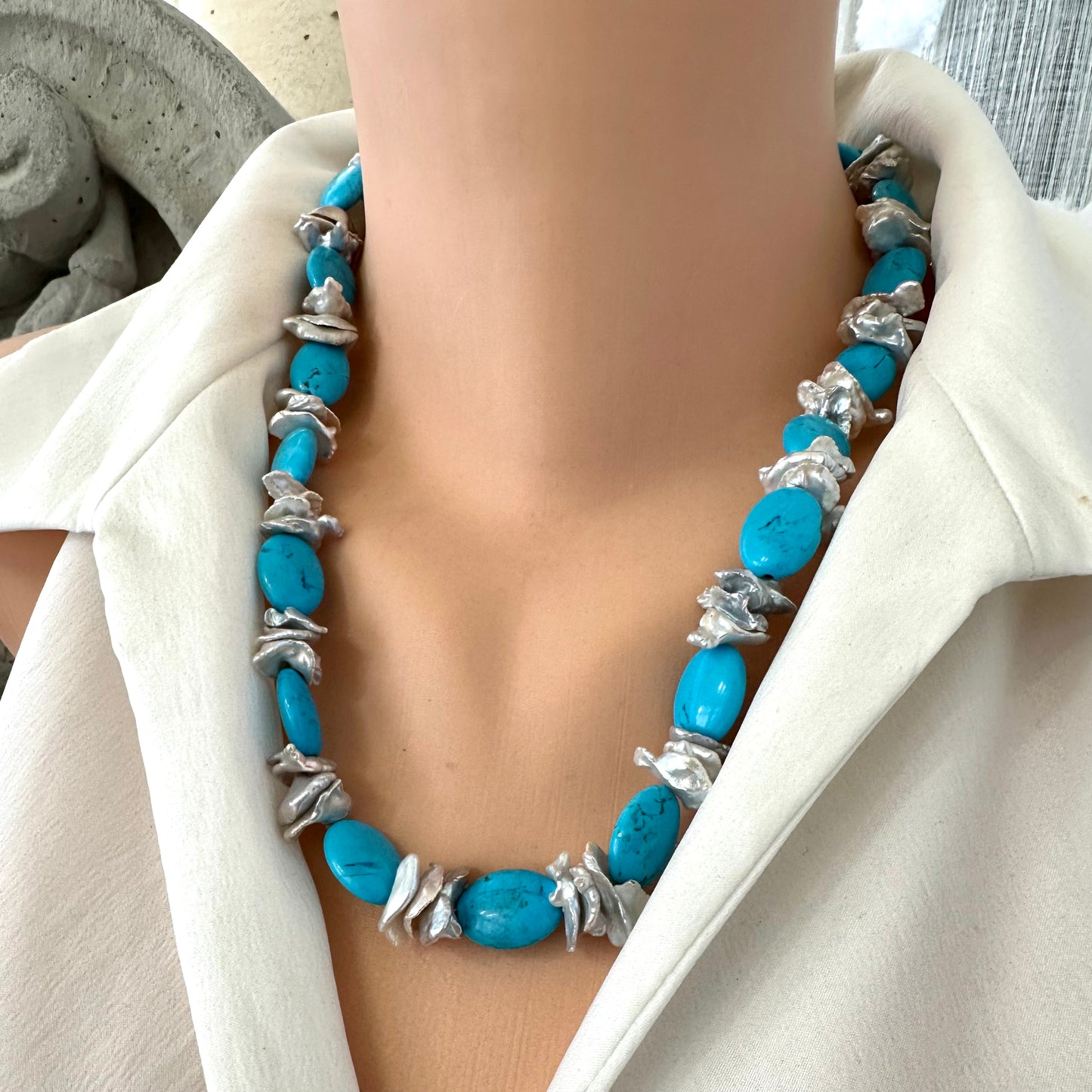 Close frontal view of chunky turquoise and silver grey keshi pearl necklace showing turquoise beads and keshi pearls