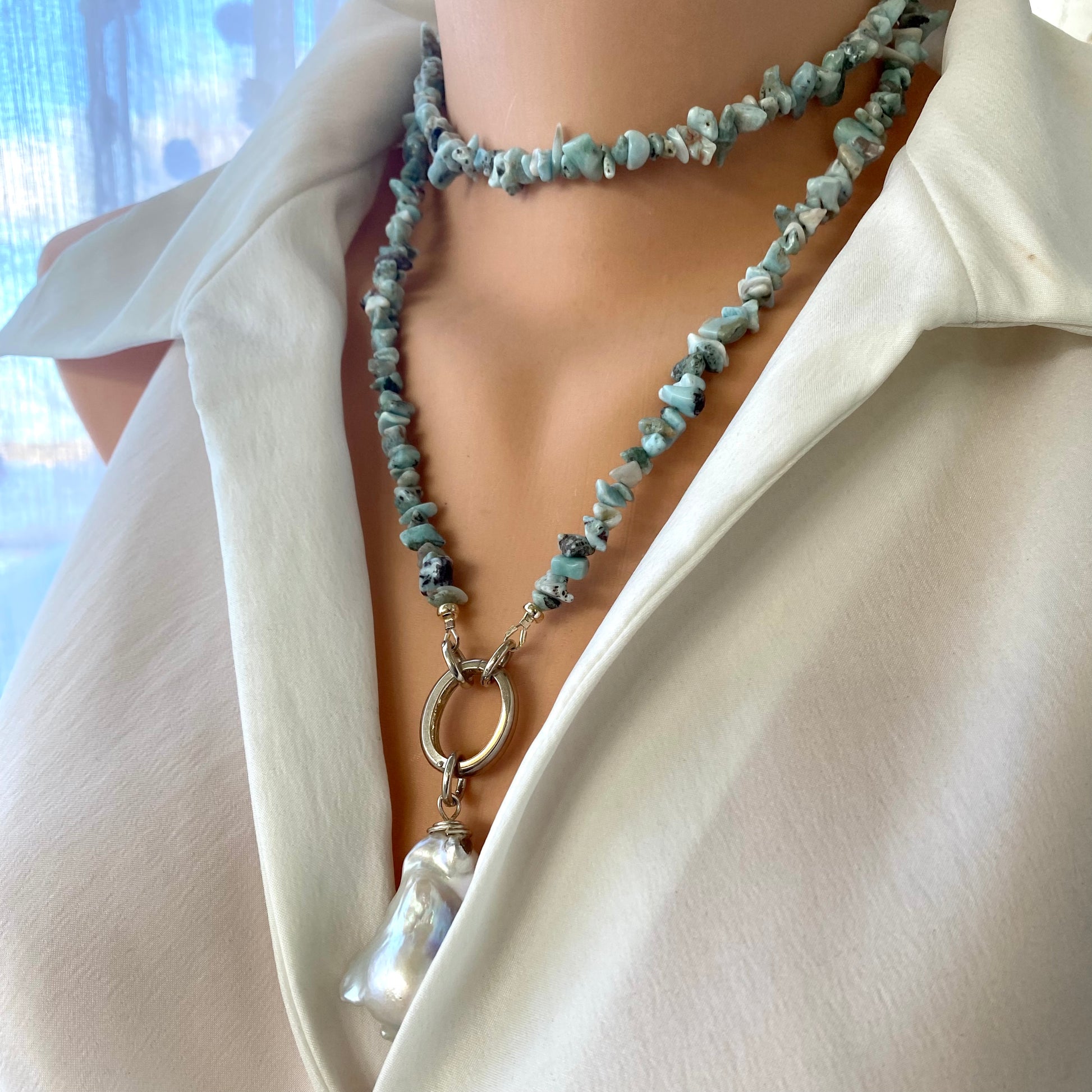 Larimar necklace with pearl pendant styled on model, ocean-inspired larimar and pearl statement necklace