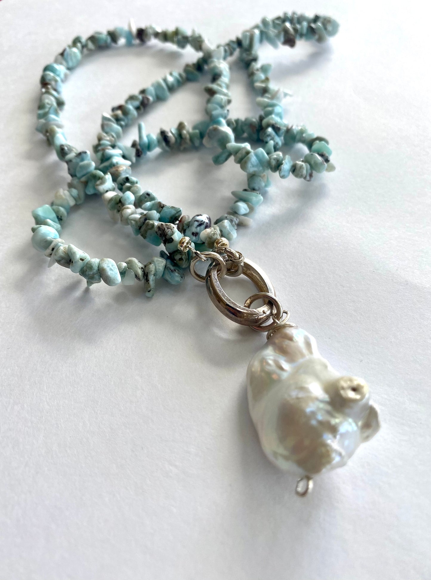 Larimar necklace with pearl pendant coiled flat lay, larimar nuggets and large freshwater pearl pendant