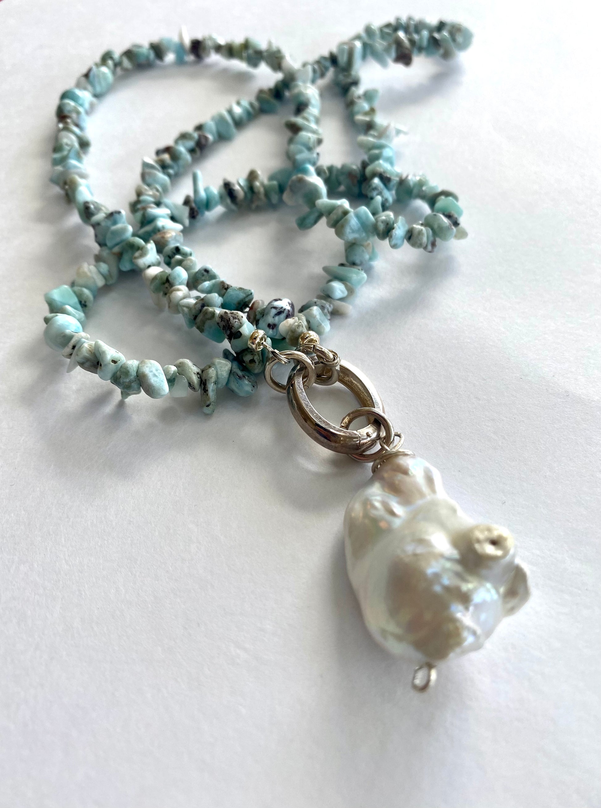 Larimar necklace with pearl pendant coiled flat lay, larimar nuggets and large freshwater pearl pendant