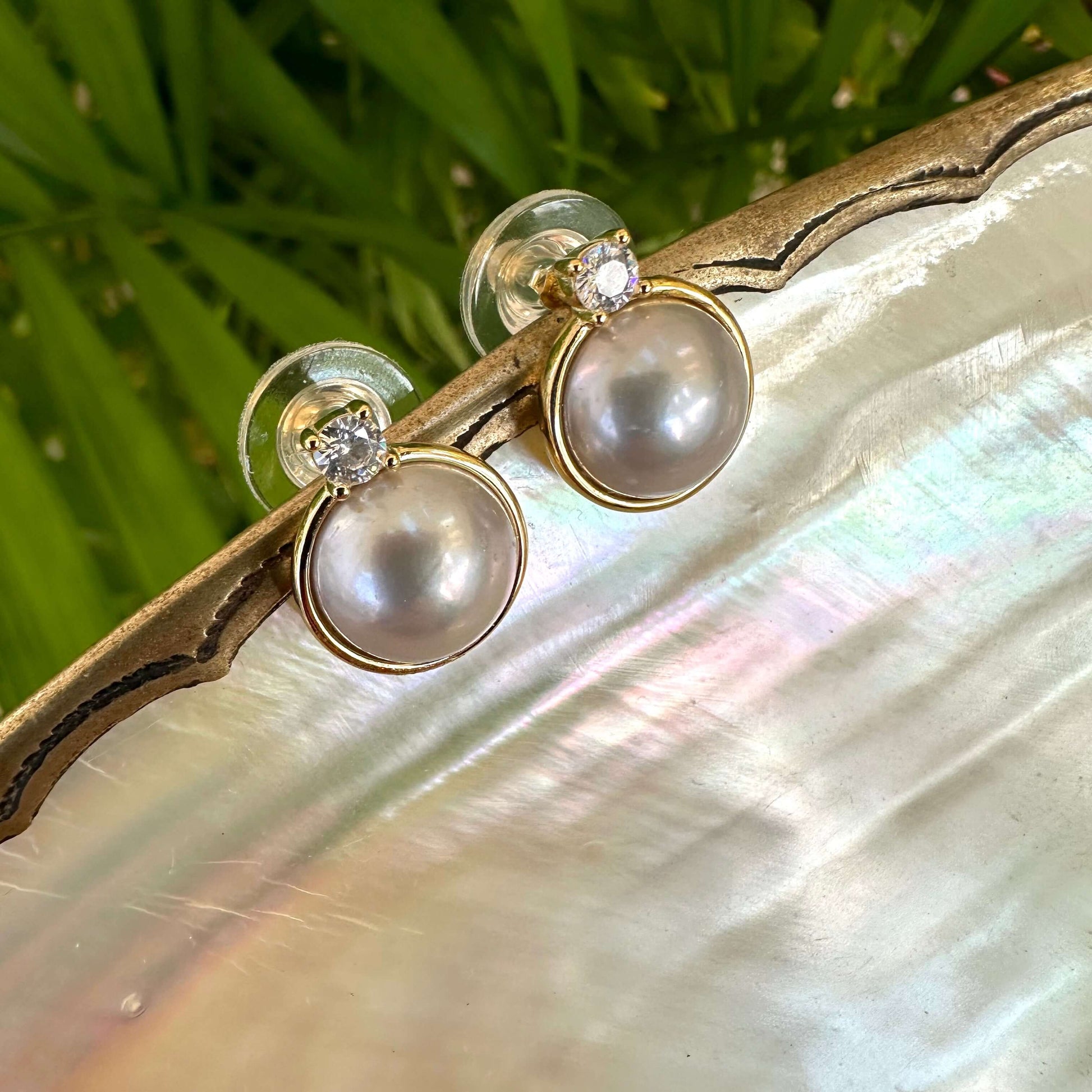Silver Grey Pearl Stud Earrings with CZ – Gold Vermeil on a shell-inspired tray, showcasing elegance and craftsmanship.