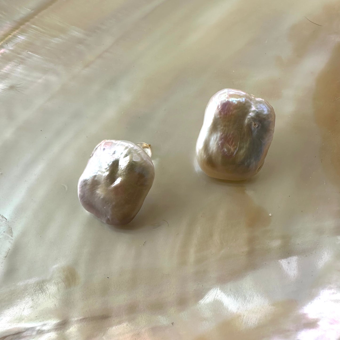 Baroque pearl stud earrings in a unique organic shape, showcasing their bold elegance and crafted in sterling silver.