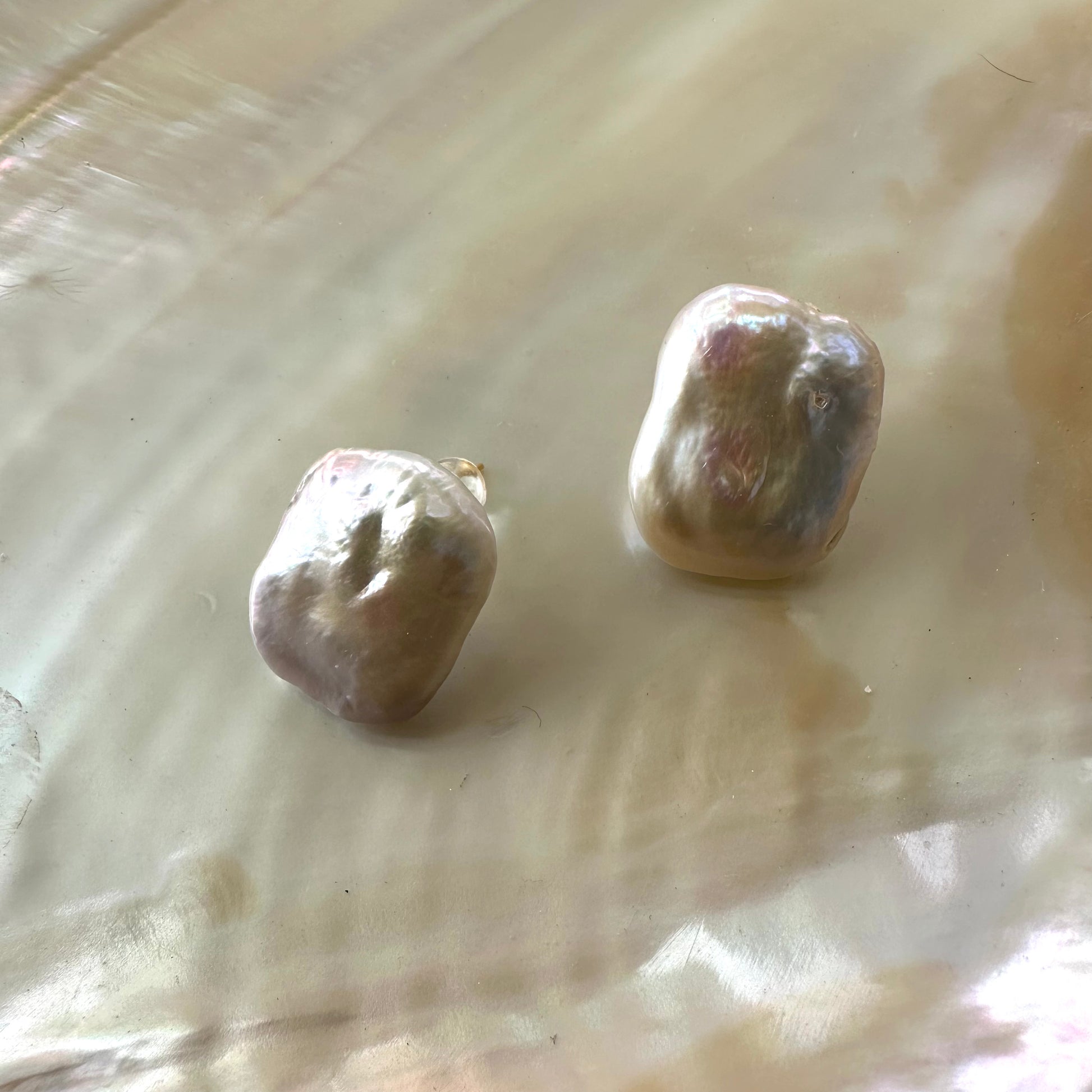 Baroque pearl stud earrings in a unique organic shape, showcasing their bold elegance and crafted in sterling silver.