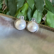 Load image into Gallery viewer, White Mabe Edison pearl stud earrings with CZ accents, set in sterling silver, minimalist and elegant, perfect for bridal jewelry or a special gift.
