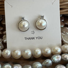 Load image into Gallery viewer, White Mabe Edison pearl stud earrings with CZ accents, set in sterling silver, minimalist and elegant, perfect for bridal jewelry or a special gift.

