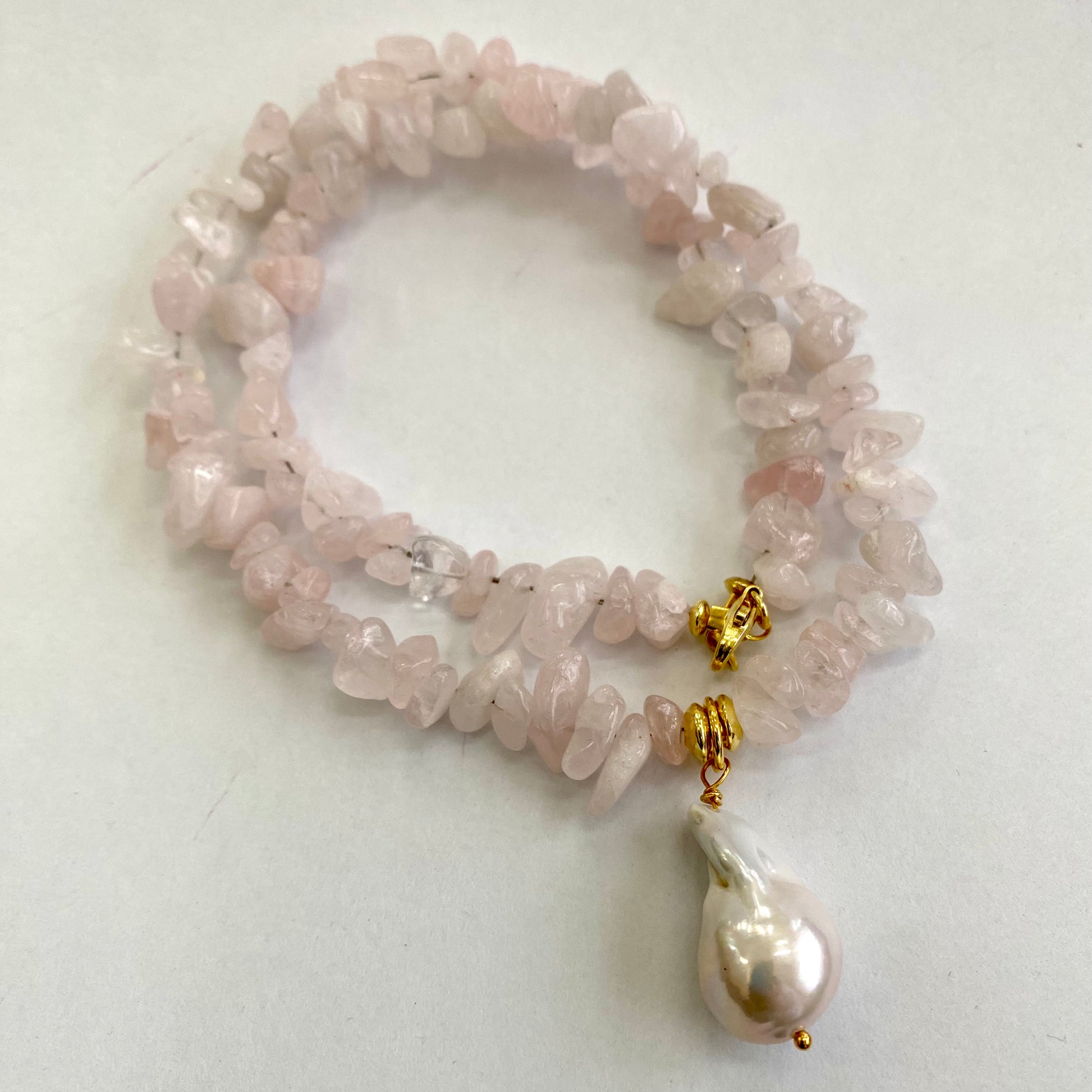 Rose quartz baroque pearl necklace featuring smooth nugget-shaped beads and a stunning Baroque pearl pendant.