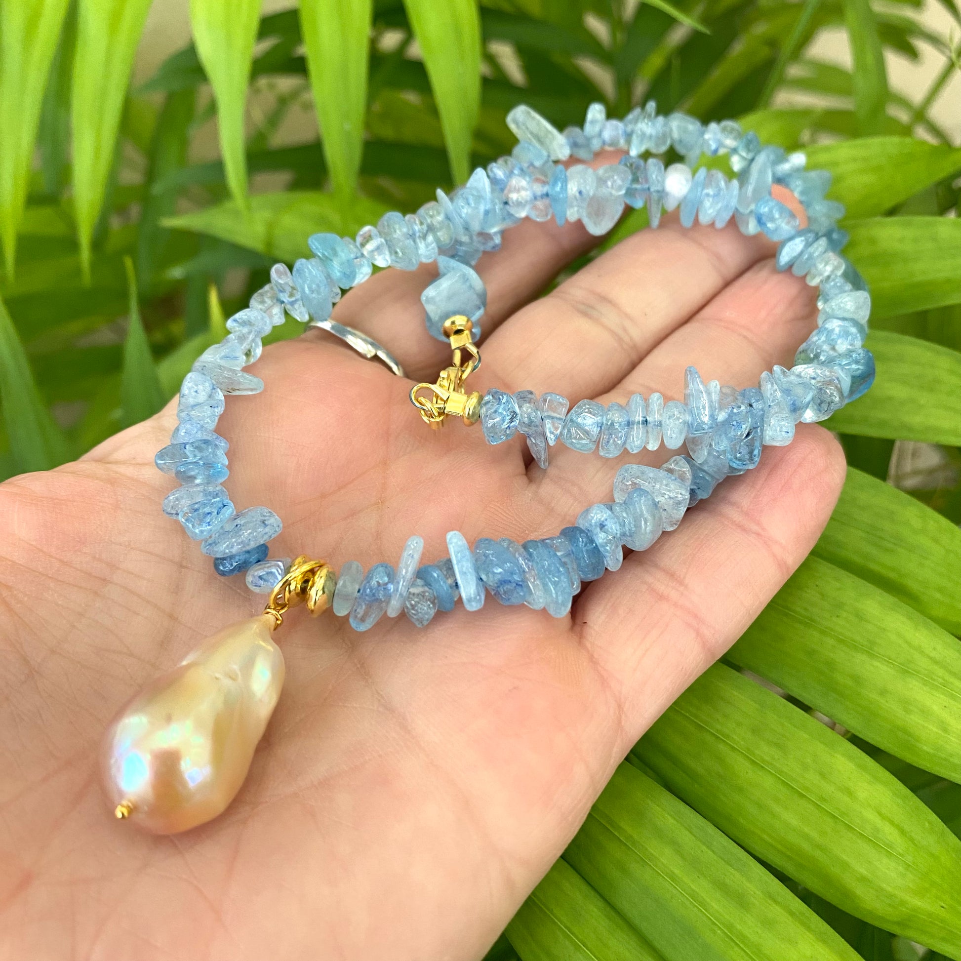 Aquamarine baroque pearl necklace featuring golden pink pearl pendant and cool Aquamarine beads.