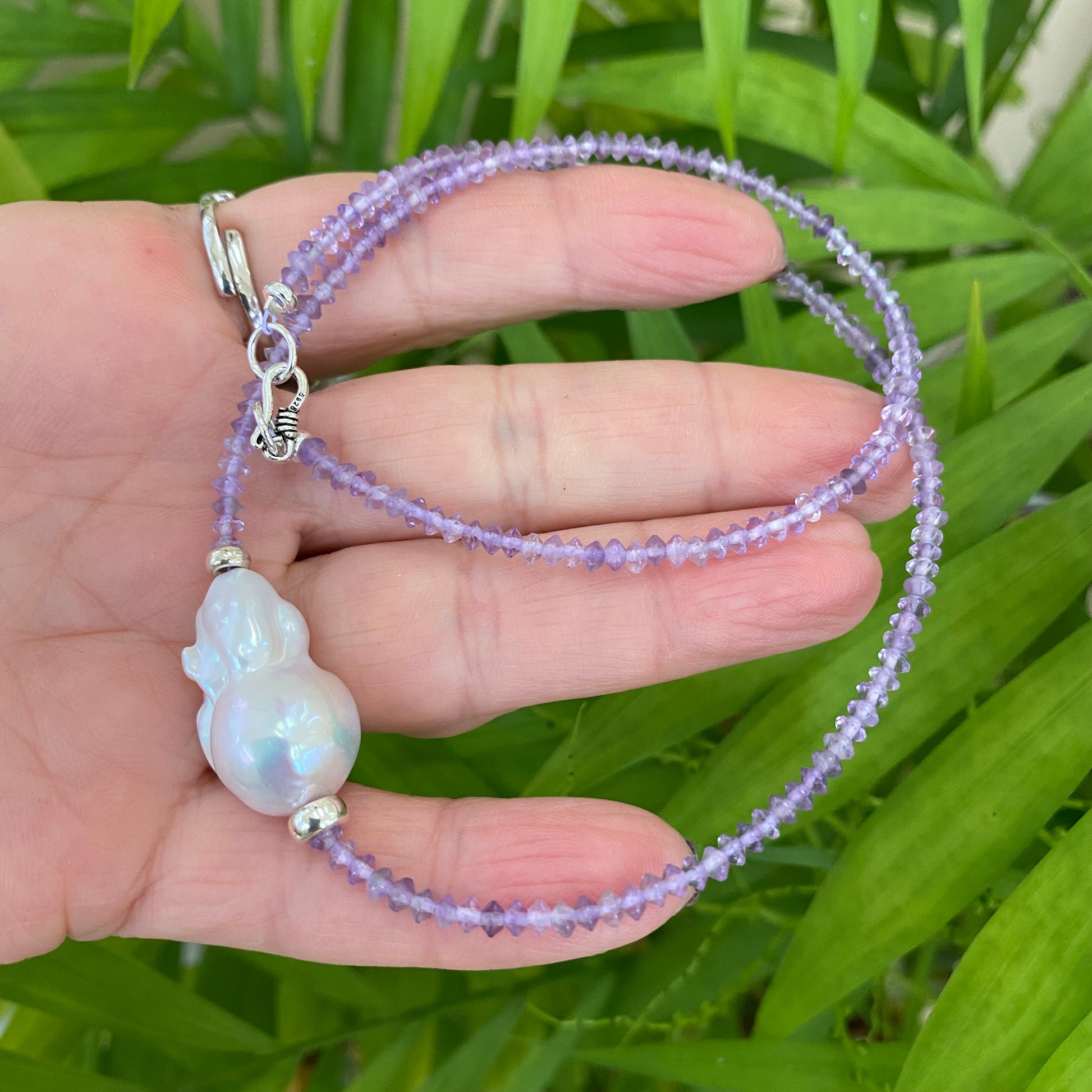 lavender amethyst baroque pearl necklace with luminous white pearl centerpiece and delicate lavender beads.