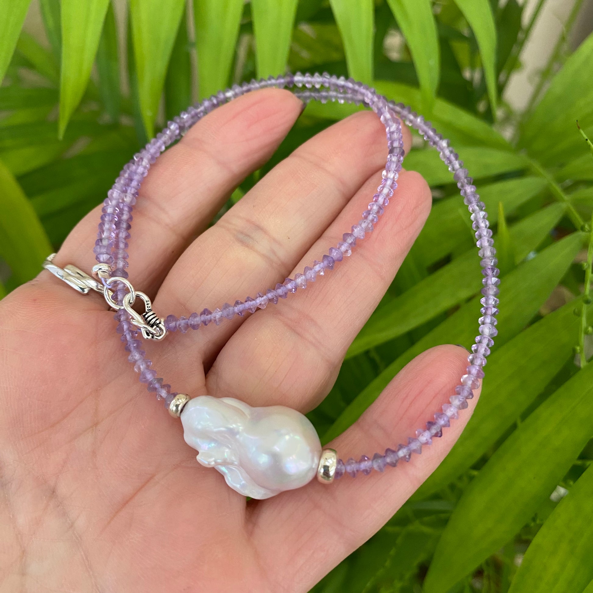 Lavender amethyst baroque pearl necklace showcasing luminous Baroque pearl centerpiece and sparkling lavender beads.