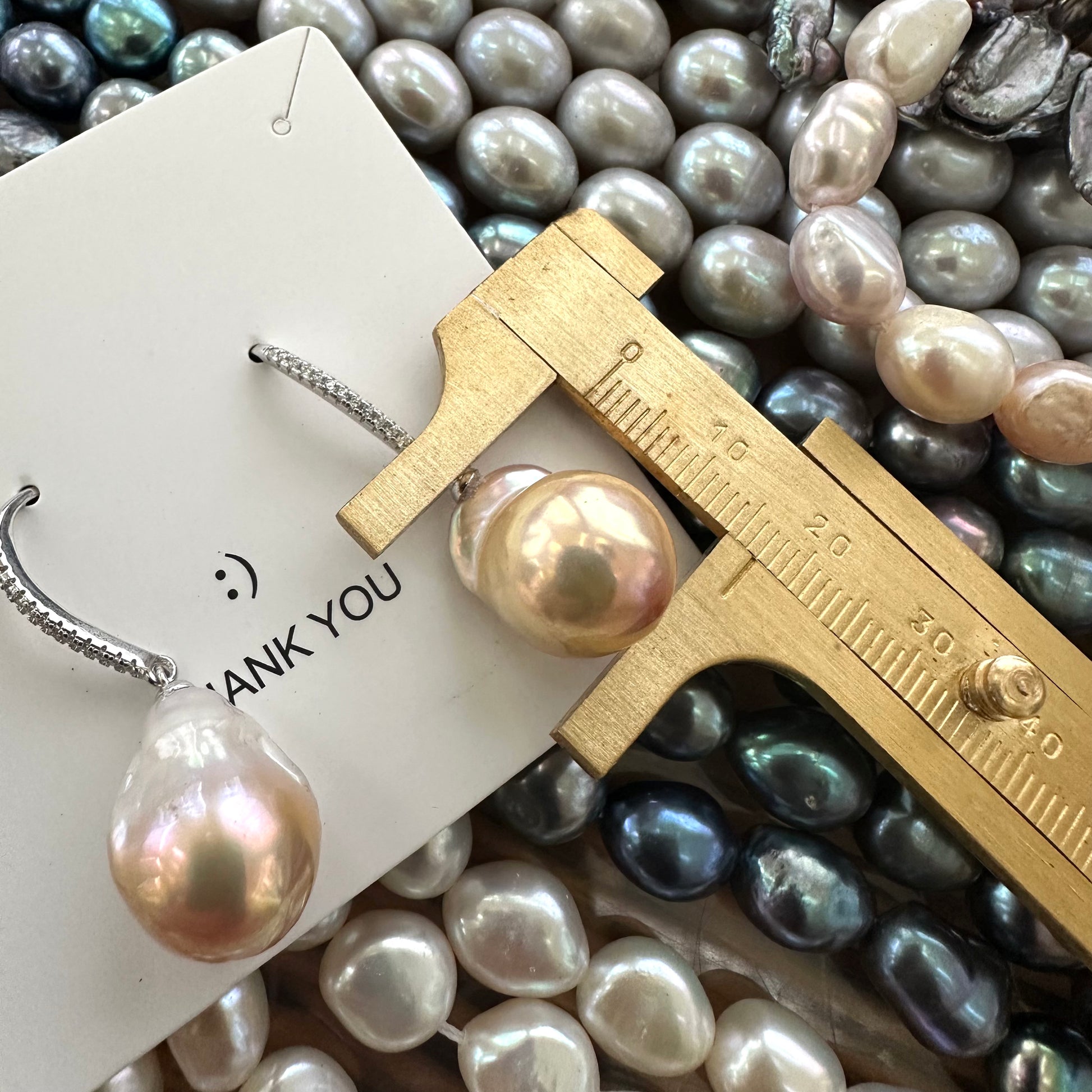 Golden pink baroque pearl dangle earrings pearl measured with ruler for size, handmade in Canada.