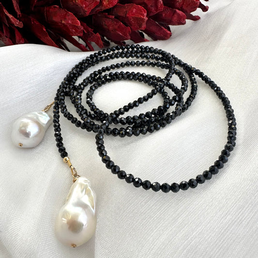 Black spinel lariat necklace with baroque pearl, featuring faceted beads and elegant design, handmade in Canada.