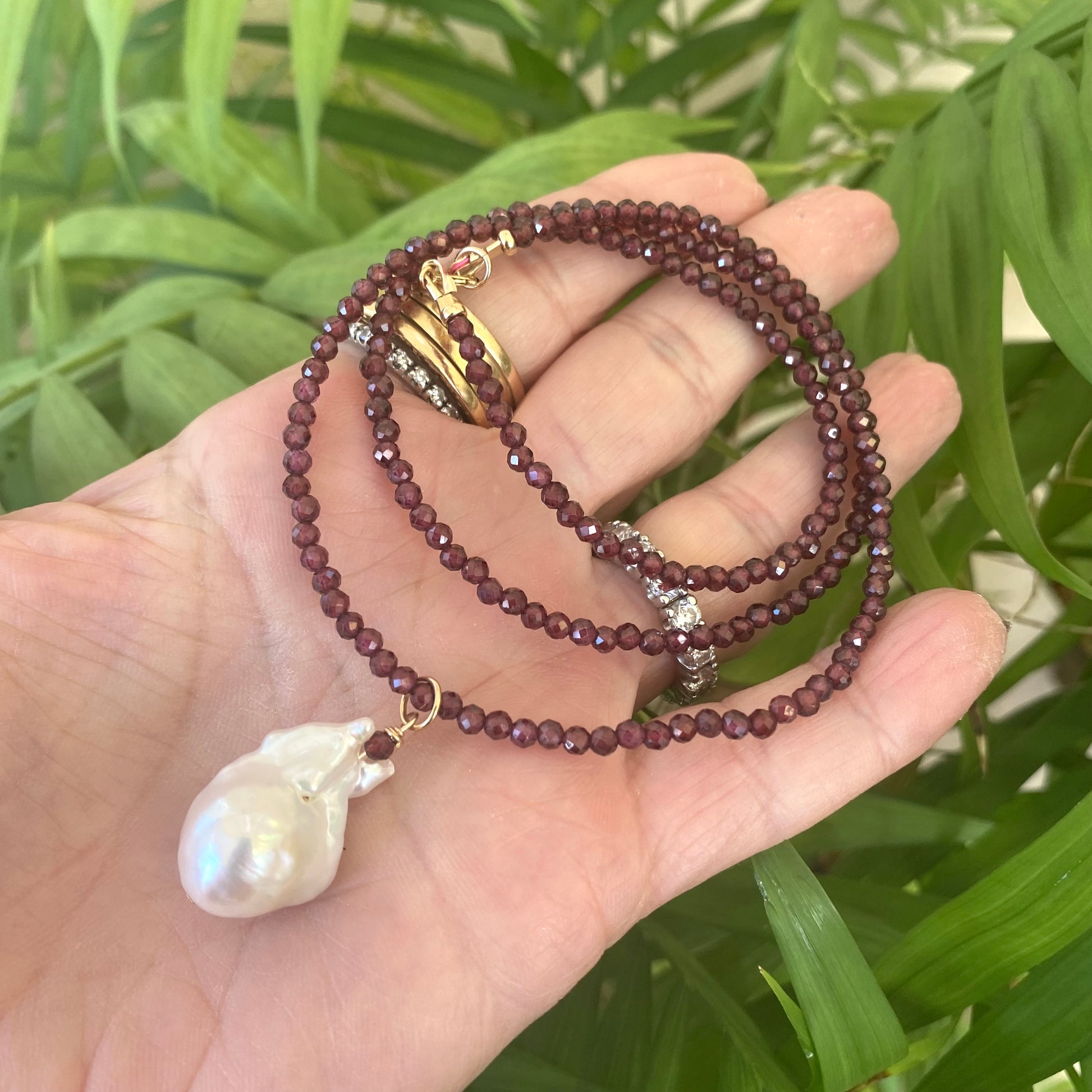 Red garnet baroque pearl necklace featuring a stunning Baroque pearl pendant and deep red garnet beads.