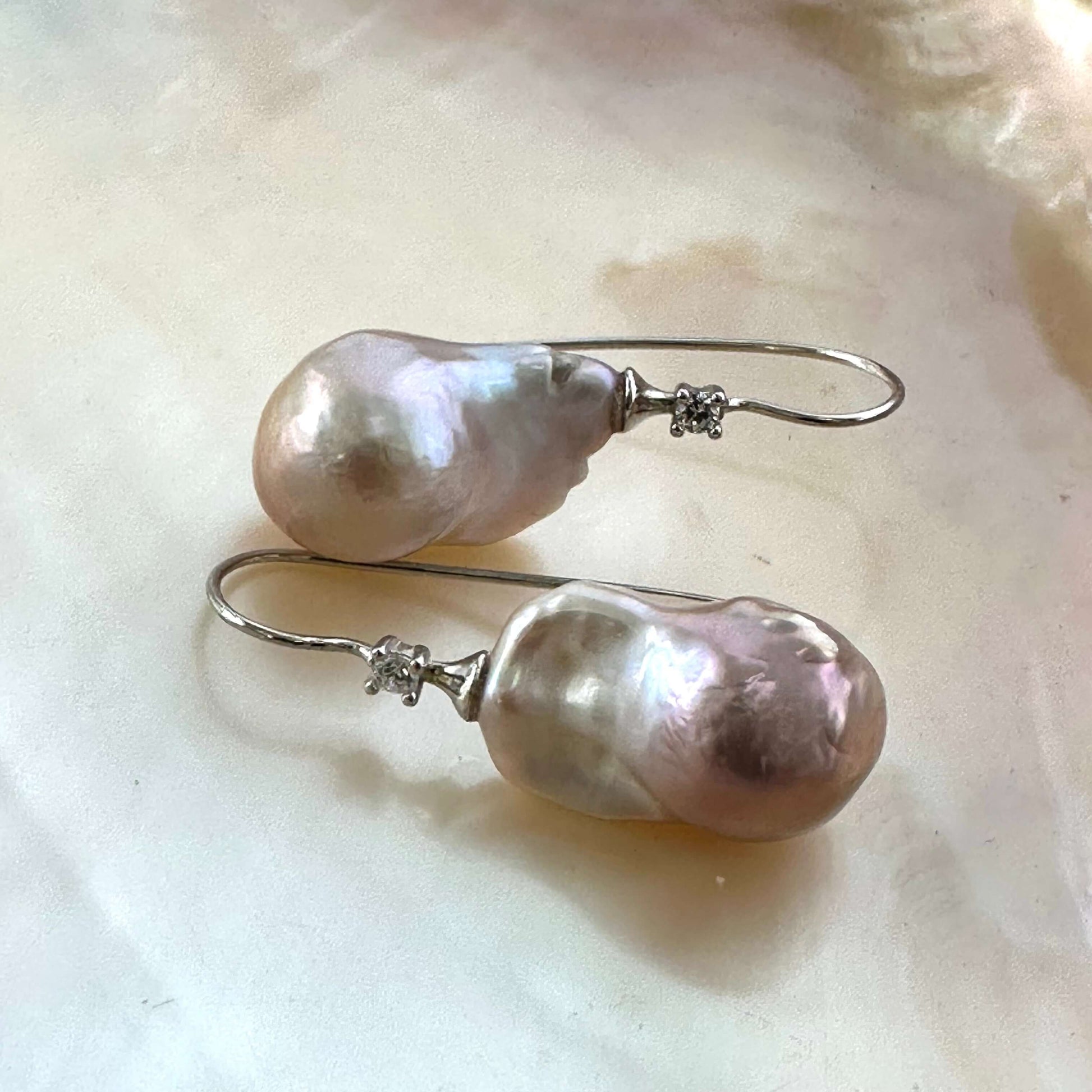 Lavender Baroque Pearl Earrings – detailed close-up on white pearl shell backdrop