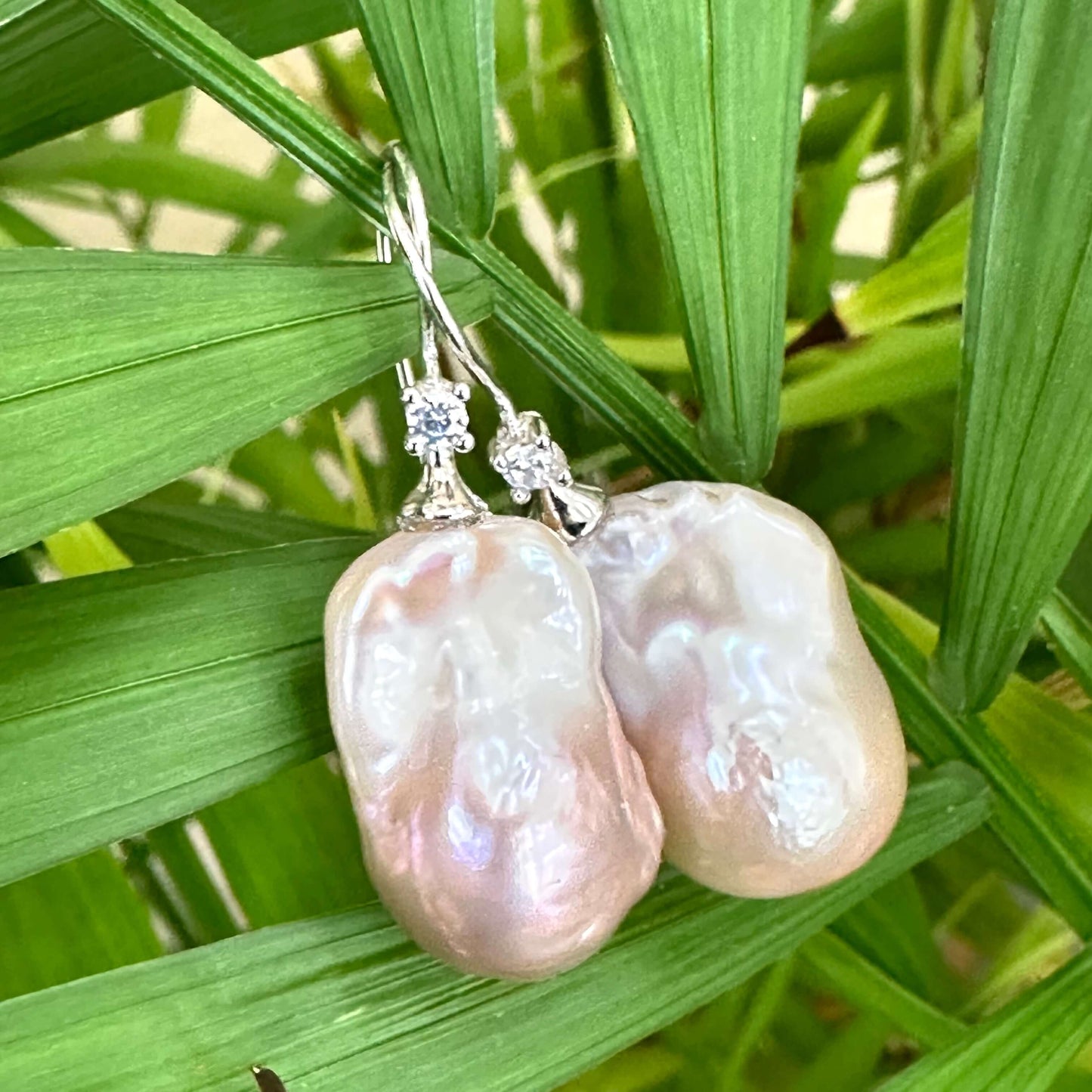 Lavender Baroque Pearl Earrings – close-up against green foliage backdrop