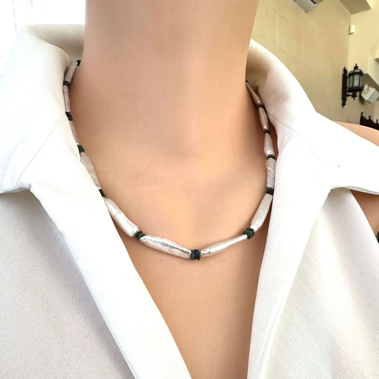 Detailed side angle of handmade biwa pearl and black opal necklace on mannequin
