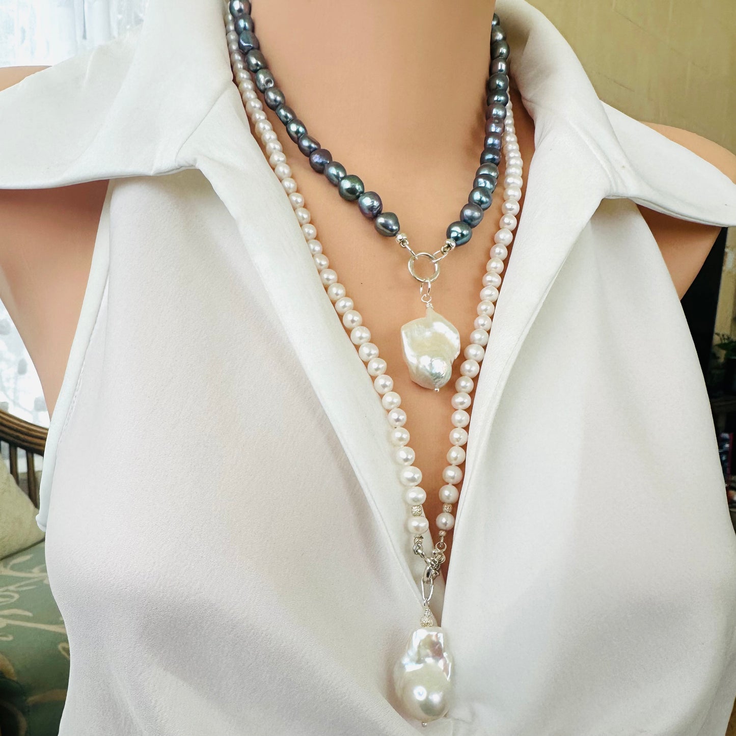 Handmade white pearl necklace with baroque pendant, elegant side angle view