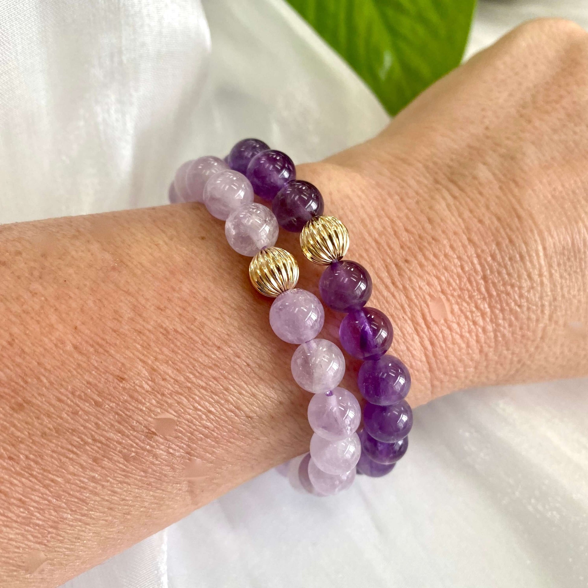 Lavender amethyst stretch bracelet on wrist, featuring 6mm and 8mm beads with 14K gold filled accents.