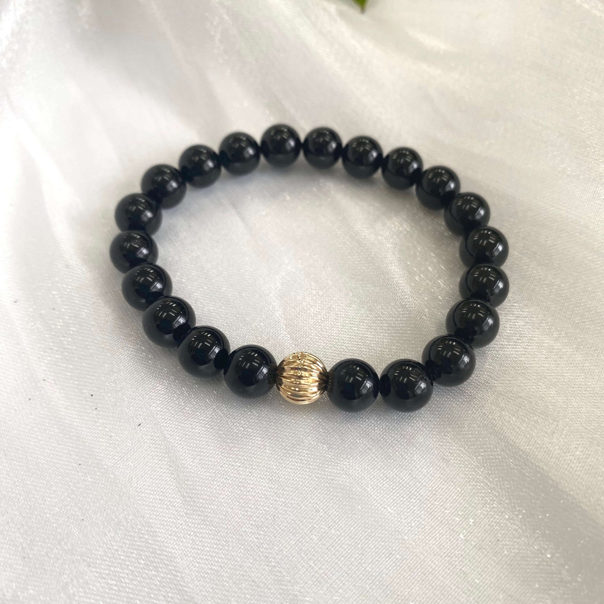 Black Tourmaline Bracelet – 8mm Beads with 14K Gold Filled accent on a silky background