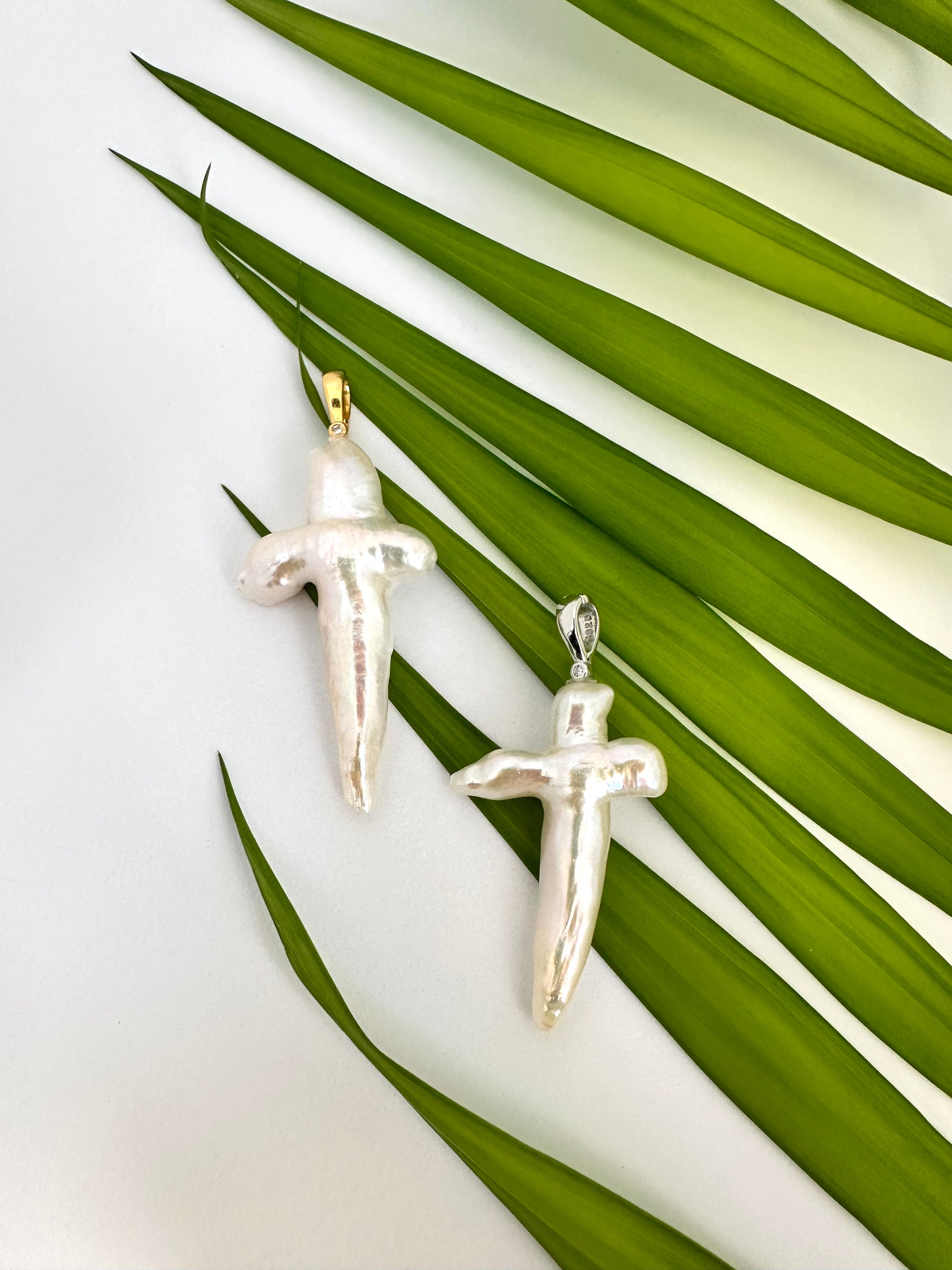 Baroque pearl cross pendant in rhodium-plated sterling silver, elegant handmade design.