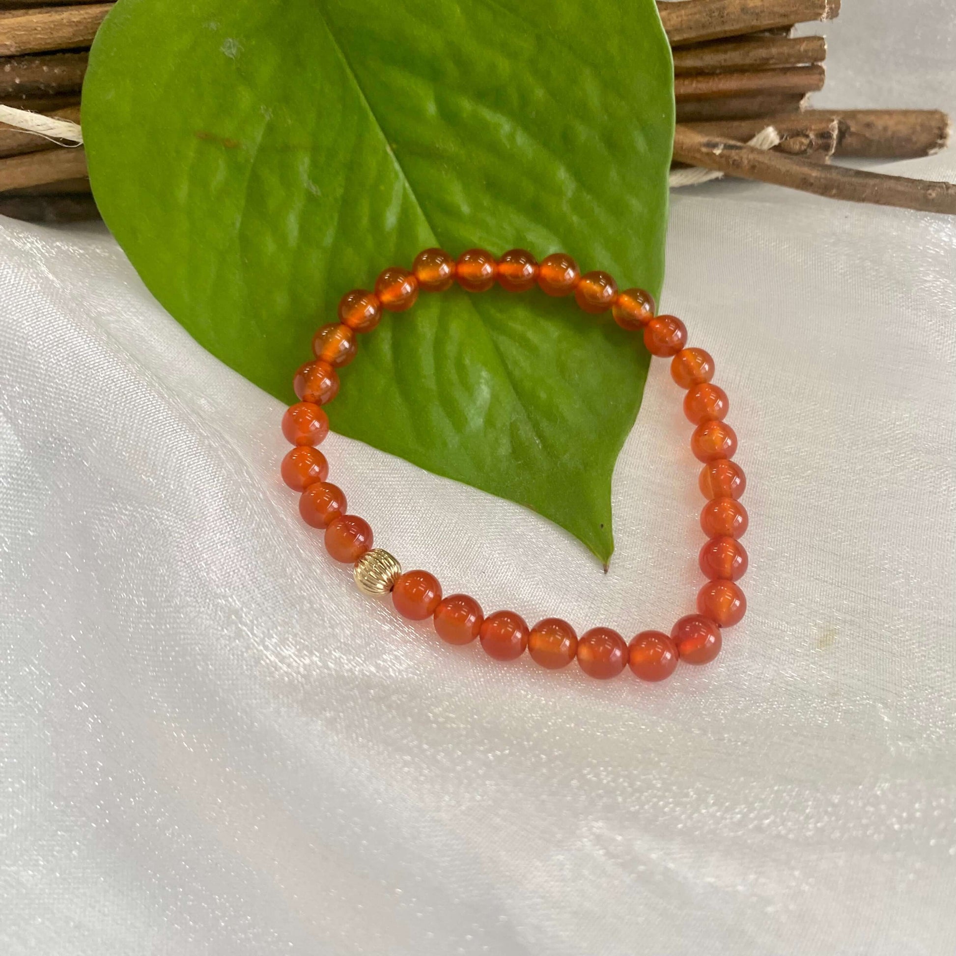Orange Carnelian Bracelet on white cloth – bead and pearl detail shot