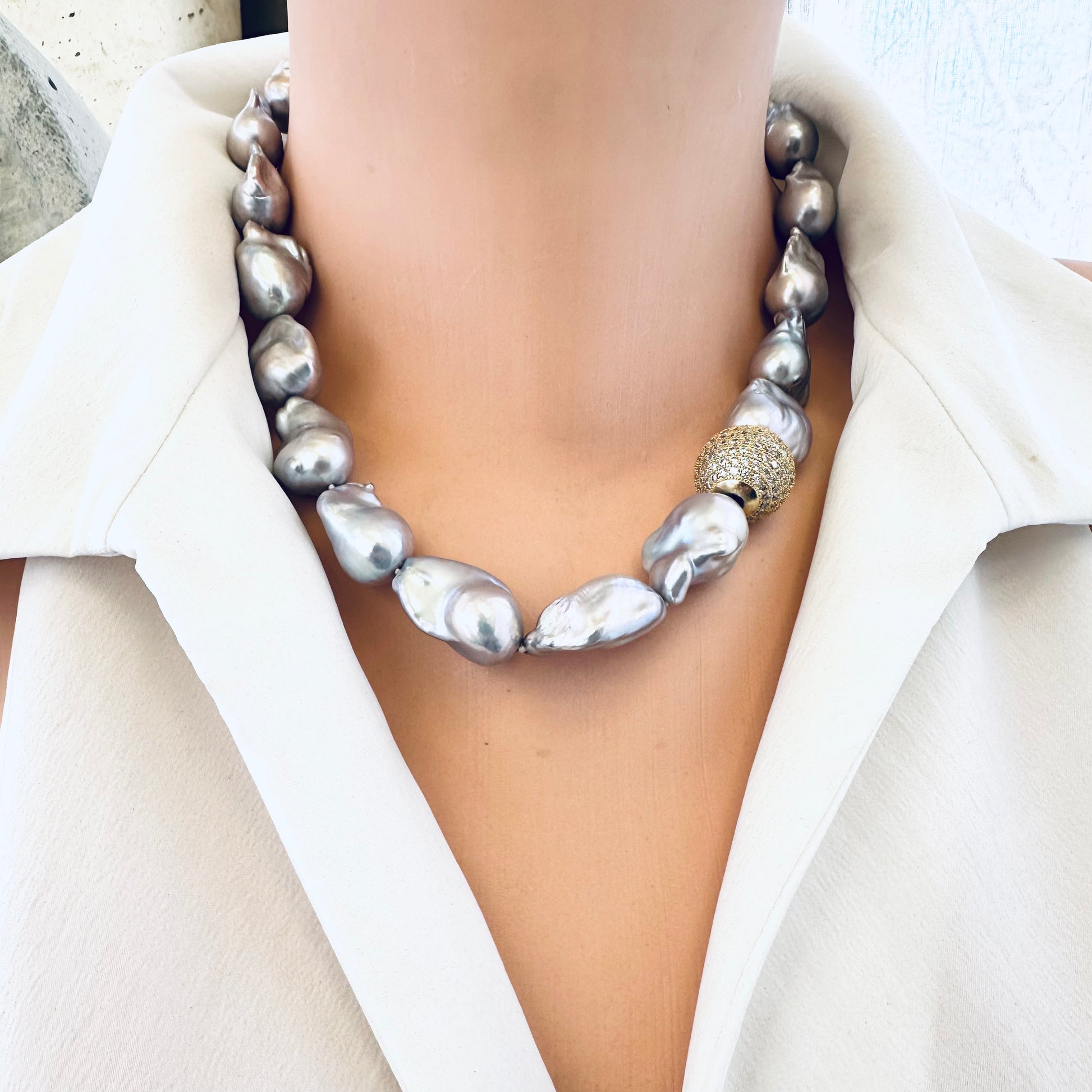 Front view of silver grey baroque pearl necklace on mannequin, elegant design
