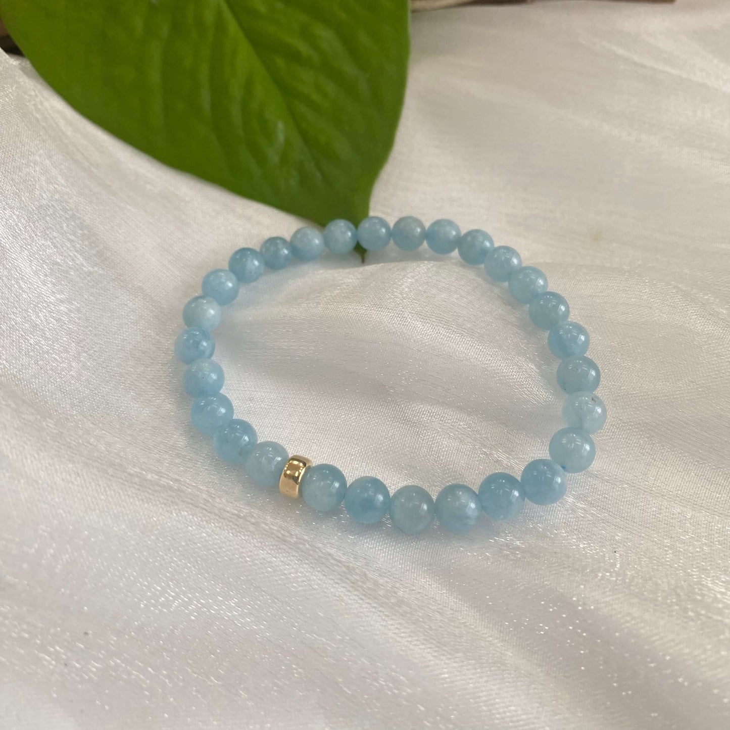 Aquamarine stretch bracelet with 6mm and 8mm beads and 14K gold filled accent.