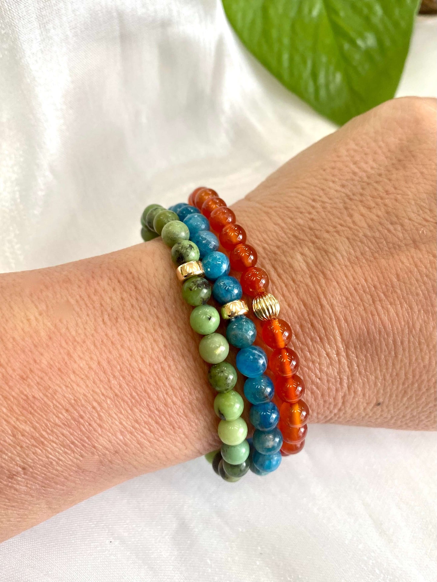 Blue Apatite Bracelet stacked with mixed bracelets on wrist – natural light shot