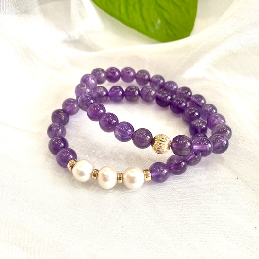Amethyst Pearl Bracelet pair on white cloth – one with three pearls and one without