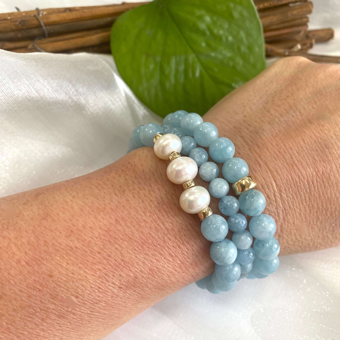 Aquamarine pearl bracelet featuring 8mm Aquamarine beads and 9-10mm freshwater pearls on a wrist.