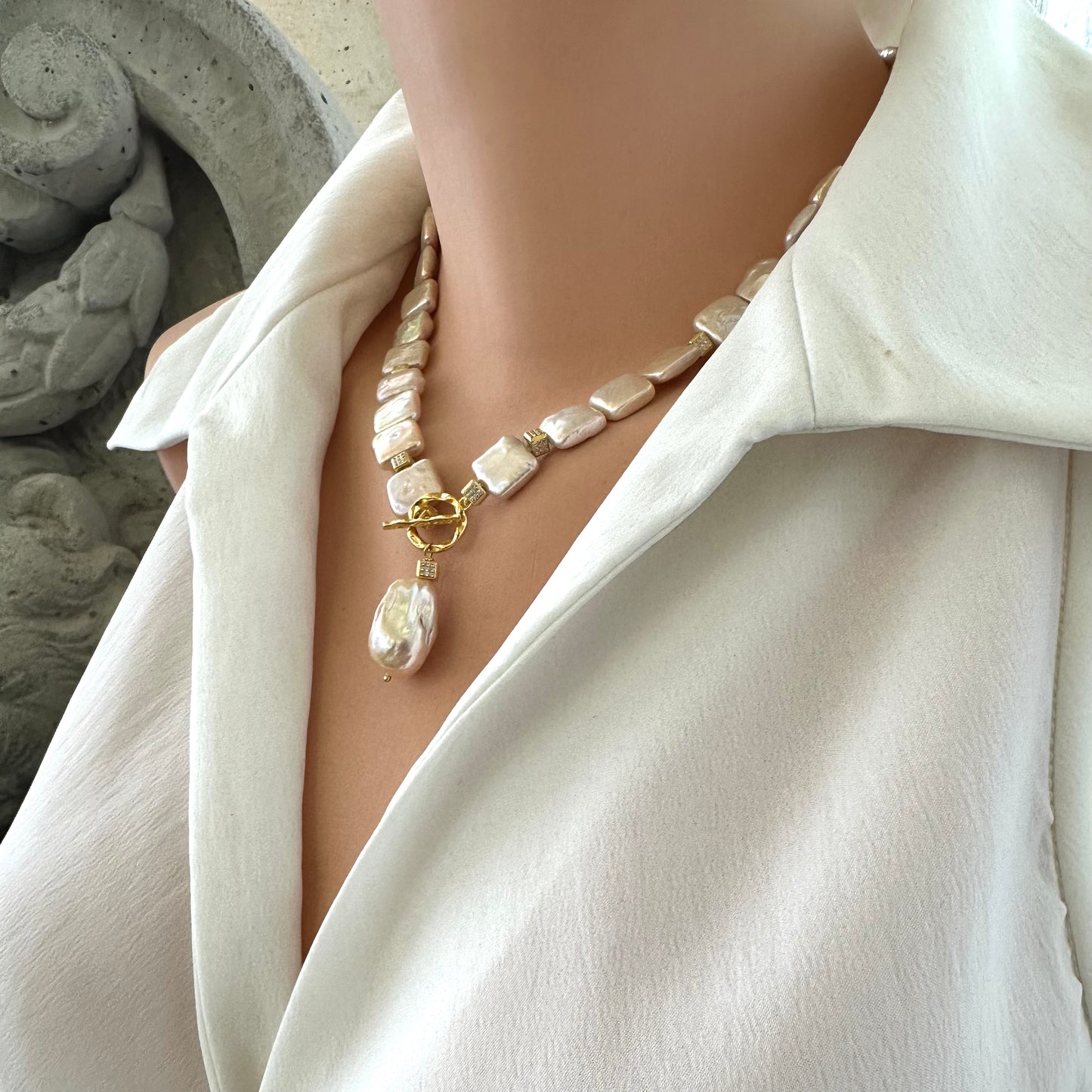 Golden baroque pearl toggle necklace on mannequin side view — handcrafted luminous pearl jewelry by Loulia Pearl Jewelry